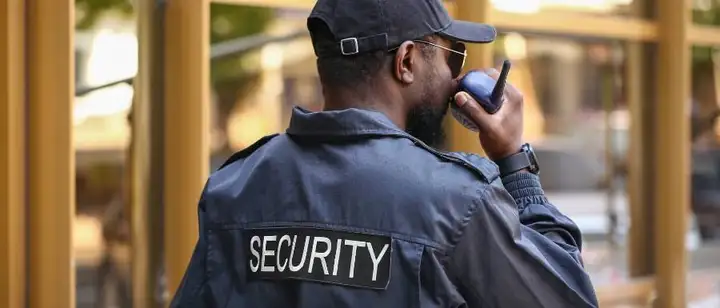 security guard talking into walkie talkie